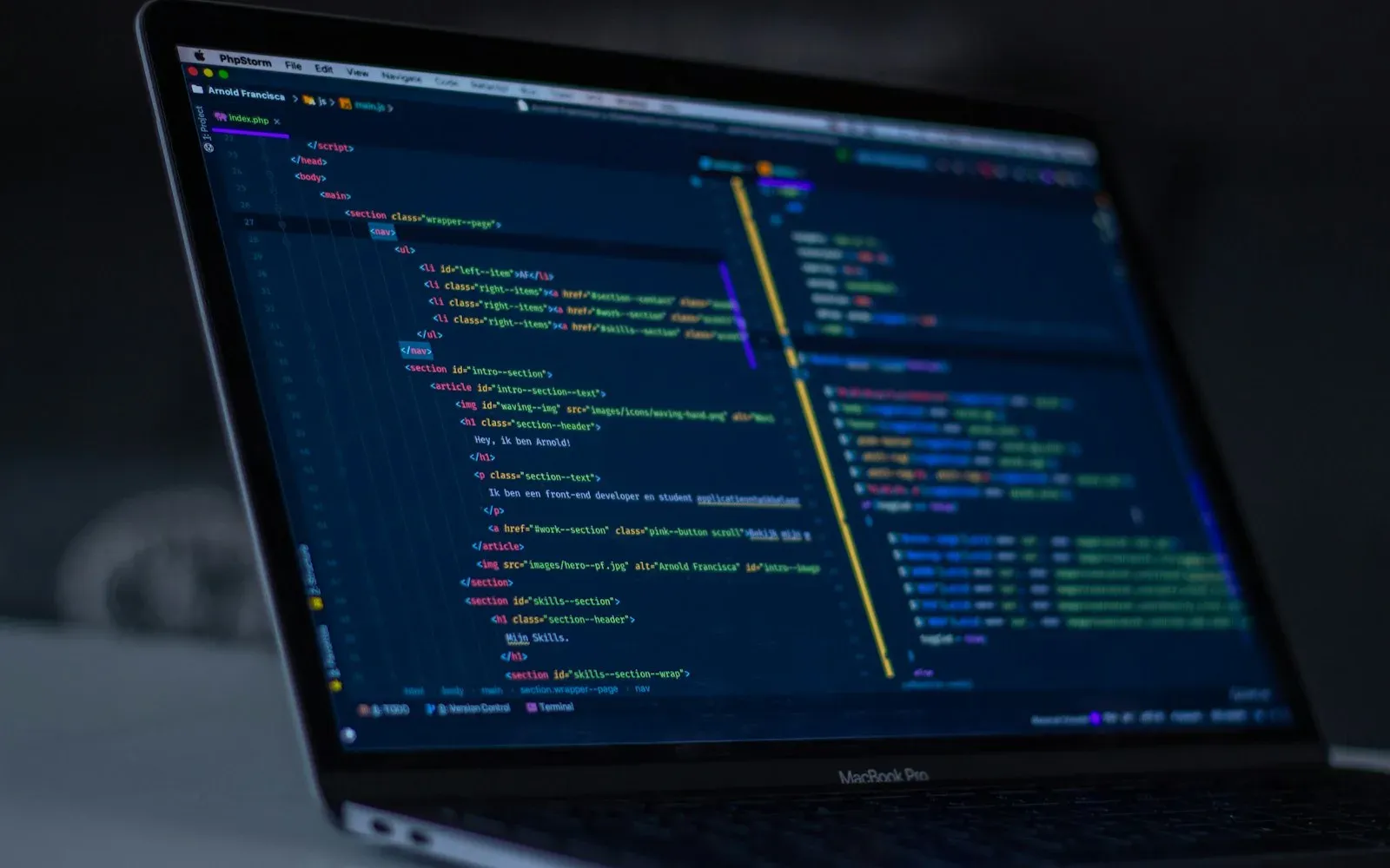 Engineer reviewing a pull request on two monitors